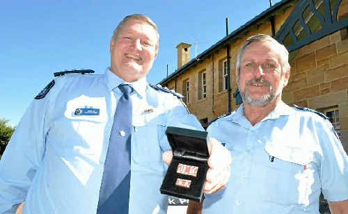Inspector Greg Morrow and Sergeant Wayne Smith receive recognition for their response to floods earlier this year. Inspector Greg Morrow and Sergeant Wayne Smith receive recognition for their response to floods earlier this year.